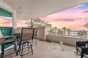 a balcony with chairs and a view of the ocean at Legacy Tower I 304 in Gulfport