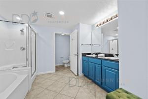 a bathroom with a shower and a sink and a toilet at Legacy Tower I 304 in Gulfport +13 photos