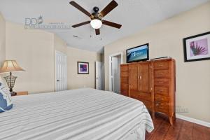 a bedroom with a bed and a ceiling fan at Legacy Villa 1504 in Gulfport +25 photos