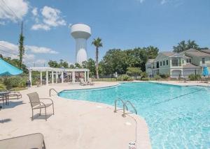 a large swimming pool with a water tower in the background at Legacy Villa 1504 in Gulfport