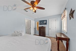 a bedroom with a bed and a ceiling fan at Oak Shores 77 in Biloxi