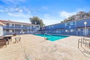 a swimming pool in front of a building at Oak Shores 77 in Biloxi +5 photos