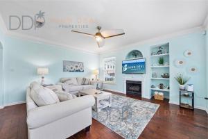a living room with a couch and a tv at Legacy Villa 1501 in Gulfport