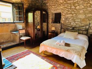 a bedroom with a bed with shoes on it at Goikitxe Etxea in Goizueta