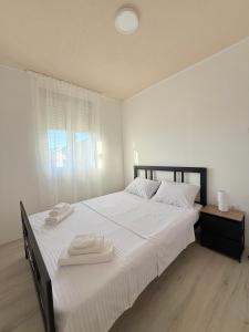 a bedroom with a large bed with two towels on it at AZA holiday in Kotor