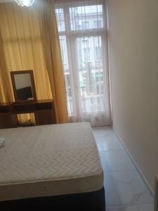 Ένα ή περισσότερα κρεβάτια σε δωμάτιο στο Guesthouse in Batumi