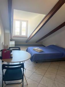 a bedroom with a bed and a table and chairs at Mansarda N12 Galliari in Turin