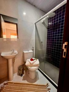 a bathroom with a toilet and a sink and a shower at Casa Brisa Noronha in Fernando de Noronha