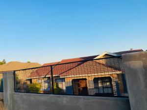 a house with a fence on the side of it at Ha-Dzibs backpackers accommodation in Thohoyandou