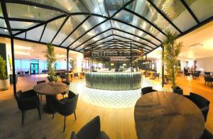 a lobby with tables and a fountain in the middle at Babmoo Beach tsikhisdziri N169 in Ts'ikhisdziri