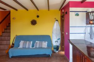 a room with a blue couch and a yellow wall at Casa Amarilla de Playa Benijo in Almáciga +45 photos