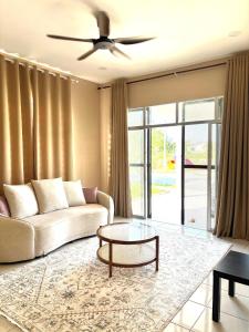 a living room with a couch and a table at House at Pantai Sepat 2BR Netflix Coway in Kuantan