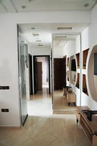 a hallway with a mirror and a couch in a room at Tru Home suites in El Jadida