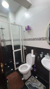 a bathroom with a toilet and a shower and a sink at Tru Home suites in El Jadida +23 photos