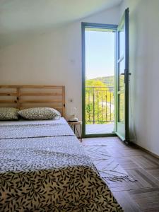 a bedroom with a bed and a large sliding glass door at House Barci in Barci