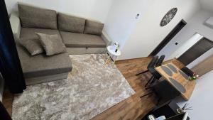 a living room with a couch and a table at Apartment Lovro in Ivanec