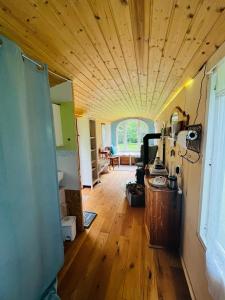 a room with a wooden ceiling and a wooden floor at HAEVN Bauwagen Marienfliess in Meyenburg