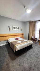 a bedroom with a large bed in a room at Newham Hotel in London