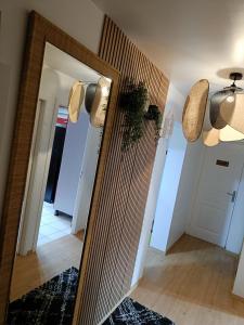 a mirror in a room with a hallway at Chambre avec salon et balcon - Gare Annemasse in Annemasse