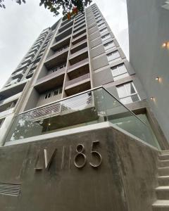 Un edificio alto con un cartel encima. en Rincón de Barrio Sur, en San Miguel de Tucumán