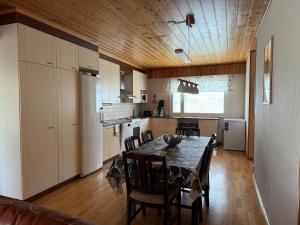 a kitchen and dining room with a table and chairs at Dream Big House Tervaharju in Kemi