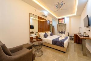 a hotel room with a bed and a living room at Hotel Chandravilas Palace in Jhālāwār