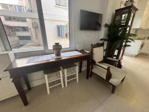 sala de estar con escritorio y ventana en Modern 2BR Apartment 70m from Finikoudes beach, en Lárnaca