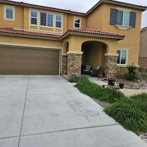 a house with a driveway and a garage at Menifee, CA in Menifee
