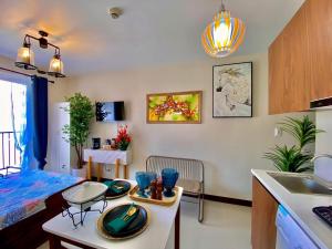a kitchen and living room with a table and a sink at Cebu Chill Studio Mactan Lapu-Lapu Cebu in Agus