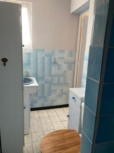 a small bathroom with a sink and a toilet at La maison bleue in Sauveterre-la-Lémance