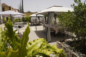 a patio with tables and chairs and umbrellas at La Casona de Arona in Arona