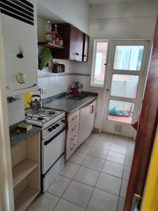 a small kitchen with a stove and a window at Dpto Saavedra Santa Fe in Santa Fe