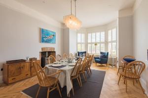 a dining room with a table and chairs at Holmwood by Keepers Cottages in Walmer