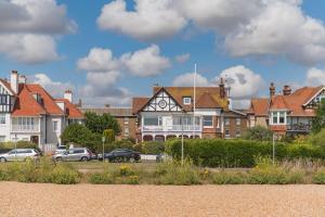 a group of houses and cars parked in a parking lot at Holmwood by Keepers Cottages in Walmer