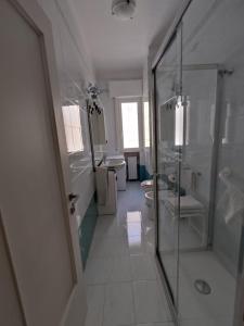 a bathroom with a shower and a toilet and a sink at HOME SWEET HOME Casa vacanze e affitti brevi in Trani +16 photos