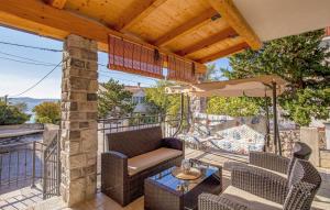 a patio with a table and chairs and an umbrella at VILLA MATIJA in Cesarica