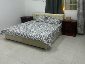 a bed in a room with two nightstands and a bed sidx sidx sidx at Apartments 2 room 1 hall R1 in Salalah