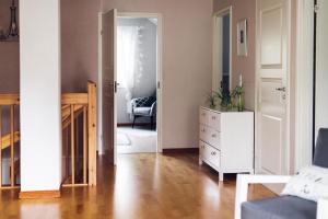 un soggiorno con cassettiera bianca e specchio di Villa Iris, Nagu a Finby Altre 3 foto