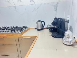 a kitchen counter with a stove and a coffee maker at apparemment sea view 01 in Tangier