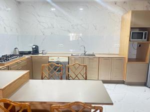 a kitchen with a table and chairs in it at apparemment sea view 01 in Tangier