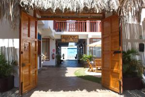 an open door to a resort with a balcony at Bungalows Rupay Wasi in Los Órganos