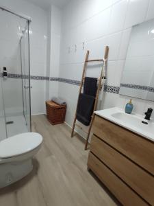 a bathroom with a toilet a sink and a shower at Luz de Calma in Tabernas