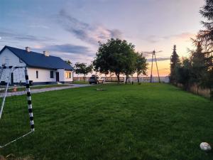a yard with a house and a soccer ball at Pod Orzechem Włoskim 1 in Mieleszyn