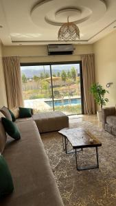 a living room with a couch and a table at Villa Azoul in Tiguemmi n Oumzil et Tnine +13 photos