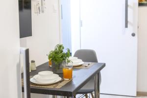 a dining room table with plates and glasses of orange juice at C-premium Apts 100m From Beach And City Centre in Larnaka
