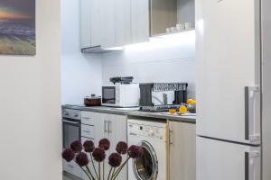 a white kitchen with a washer and dryer in it at C-premium Apts 100m From Beach And City Centre in Larnaka