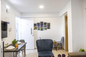 a living room with a table and a dining room at C-premium Apts 100m From Beach And City Centre in Larnaka