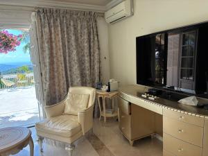 Μια τηλεόραση ή/και κέντρο ψυχαγωγίας στο Villa Gloria Nouvel Hôte