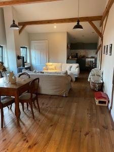 a bedroom with a bed and a table and a dining room at Stylish Loft Apartment on a Country Farm in Bad Fallingbostel