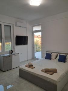 a bedroom with a large bed with towels on it at Apartments BIA in Gevgelija